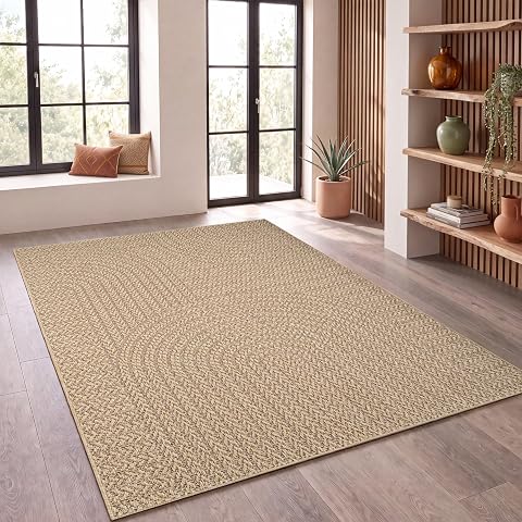Tapis rectangulaire effet jute beige et noir posé à plat sur une terrasse en pierre claire.